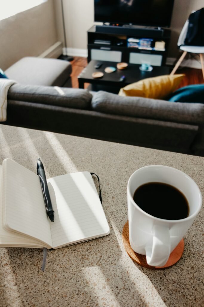 jotting down quick tasks with coffee on desk