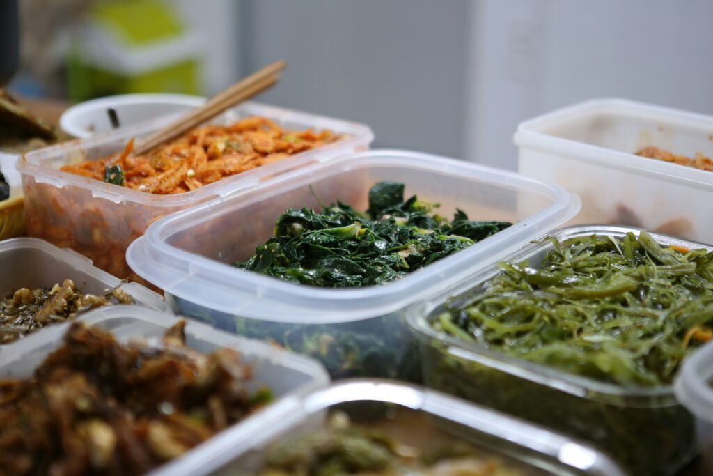 Meal prep containers with neatly stored cooked vegetables and sides