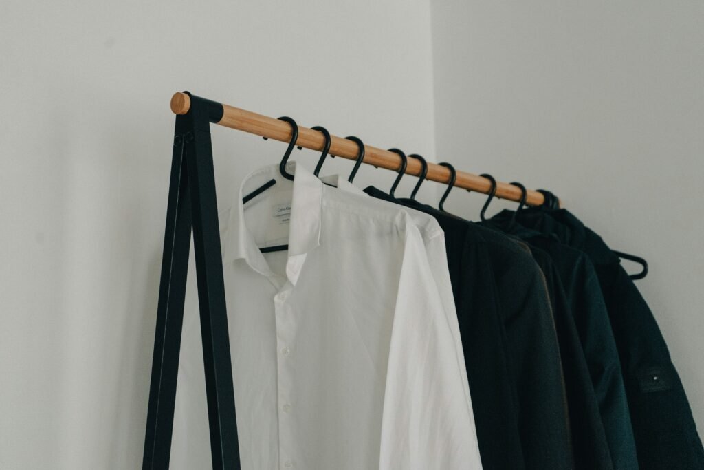 neatly organized minimalist wardrobe with white clothing