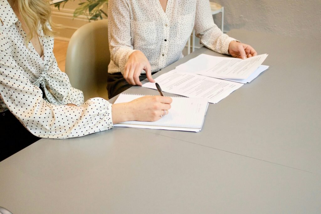 Tutor helping a student with homework at a desk