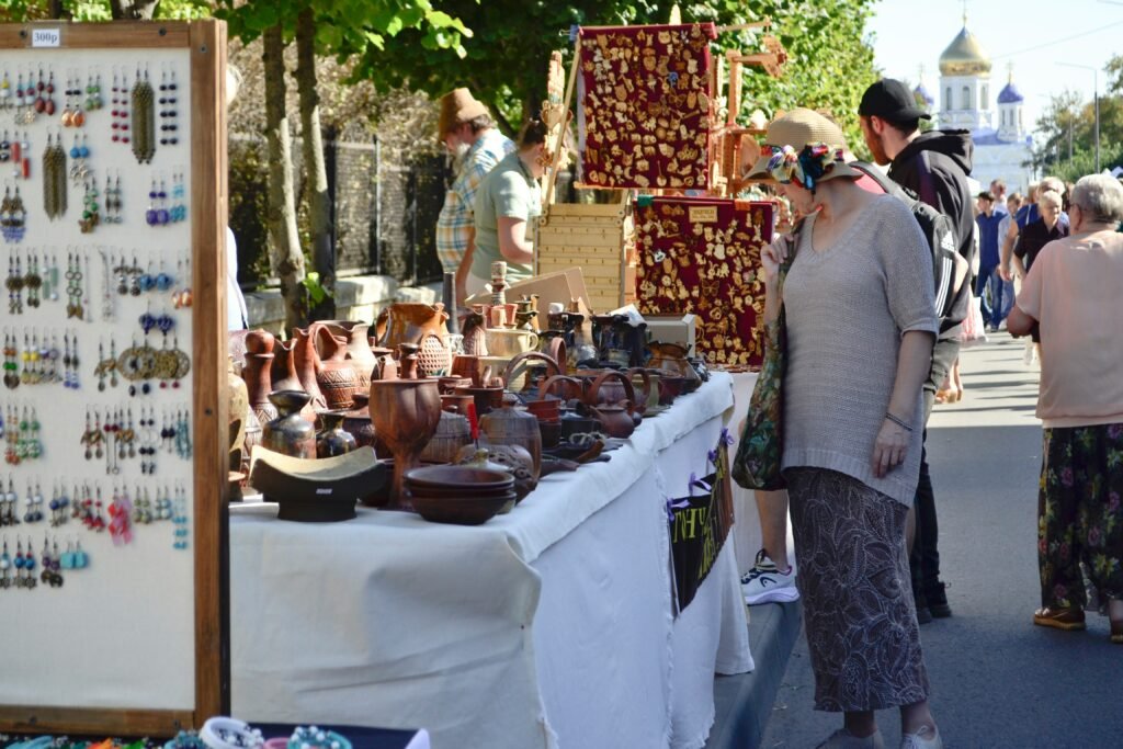 Vendors selling handmade crafts at a local outdoor market

