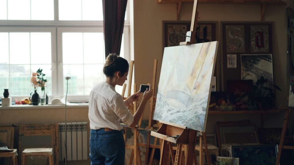 Person painting on a canvas in a bright studio, representing time freedom