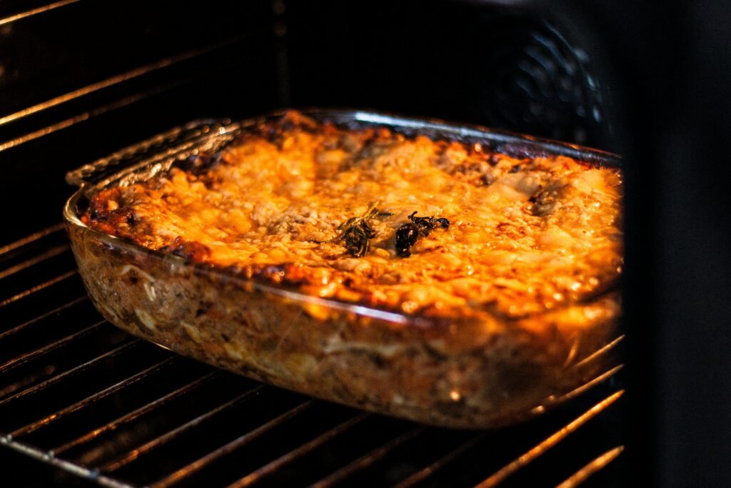 Homemade lasagna in casserole dish prepared for freezing