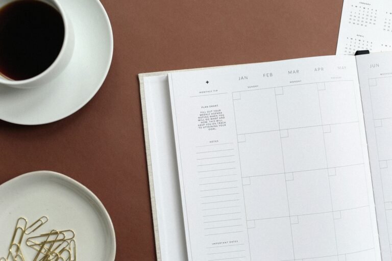 Healthy meal planning on a budget with a calendar and coffee on a wooden desk