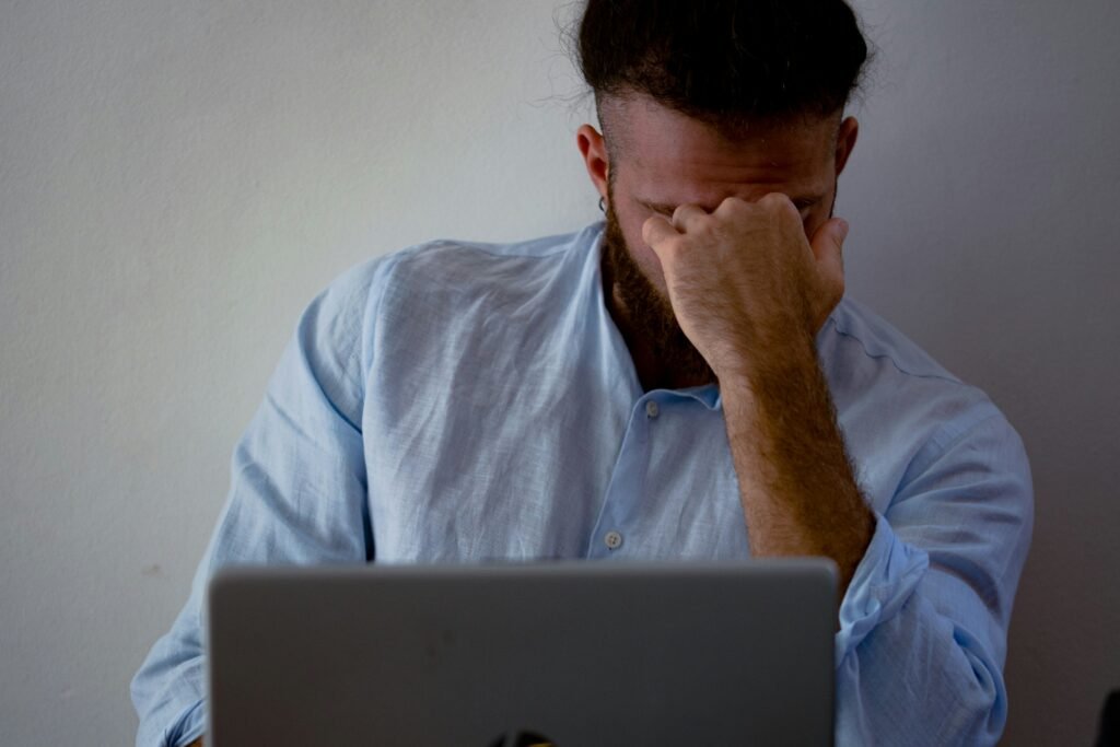 Frustrated man realizing pay-to-work side hustle scam