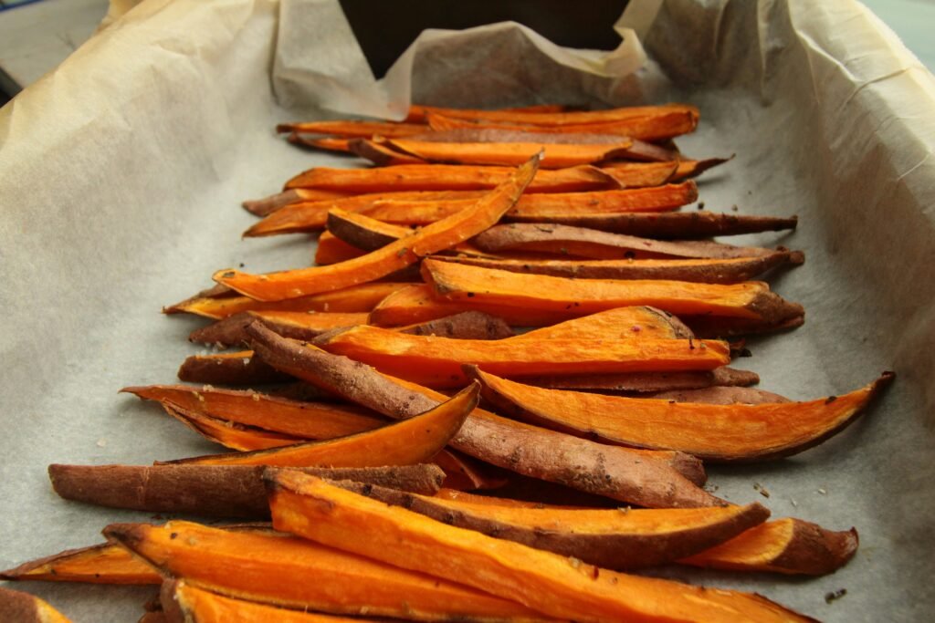 Sheet pan filled with roasted carrots as part of weekly batch cooking prep