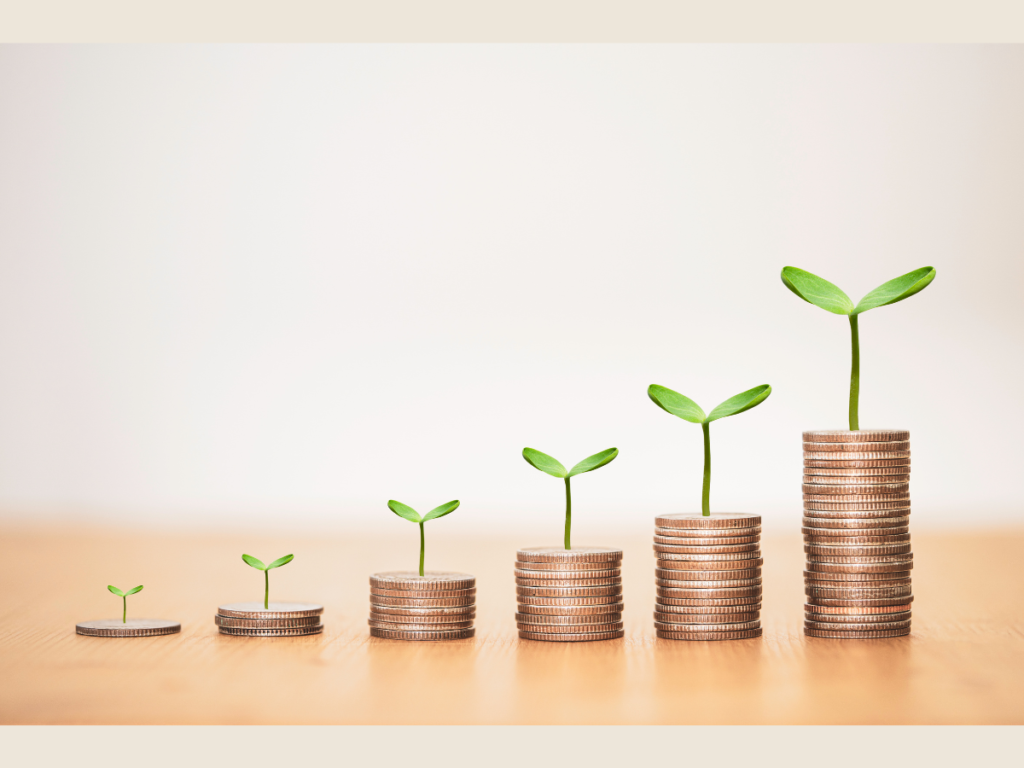 Stacked coins with growing plants symbolizing financial growth and steady passive income