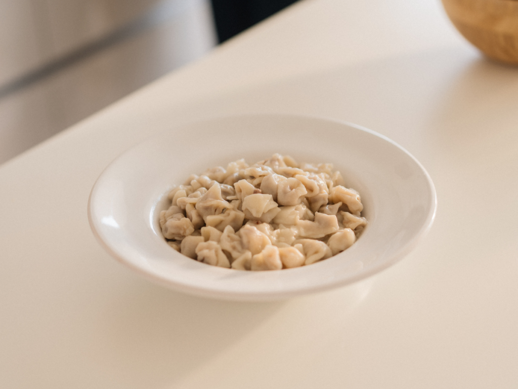 A simple minimalist meal in a white bowl, showing the kind of uncomplicated food made during the one-bag week.